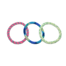 Load image into Gallery viewer, These &quot;Aloha Roll Ons&quot; come as a set of three.  They are handmade with love by women artisans in Nepal, using high quality glass beads and hand-dyed cotton thread. These bracelets will expand over your hand to fit most wrist.   The purchase of these bracelets empowers female artisans through fair trade. Your purchase provides women with fair income + benefits in a safe and healthy work environment. Aid Through Trade empowers women by creating opportunity through beautifully designed jewelry.
