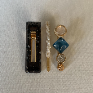 Style your hair with these beautiful trio of hair clips. It is the perfect accessory to any outfit! Blue/grey clip; blue and shimmering opal clip; and a simulated pearl pin. Can be worn each as a single clip or pin or stacked together. You can also mix and match with another favourite clip of yours!  Three pieces