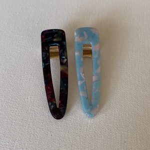 Style your hair with these beautiful duo clips. It is the perfect accessory to any outfit! One clip is dark multi-colour & second clip is baby blue with pink colour. Can be worn each as a single clip or together. You can also mix and match with another favourite clip of yours!  Two pieces