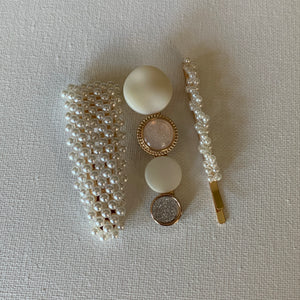 Style your hair with this beautiful set of three hair clips. Two are simulated pearl hair clips with a pink/white clip. They are the perfect accessory to any outfit! These clips can be worn each as a single clip or together. You can also mix and match with another favourite clip of yours!  Three pieces 