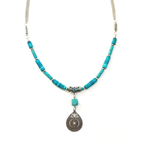 This beautifully handcrafted genuine turquoise howlite necklace has a white gold plated charm. Turquoise howlite is a great stone to reduce anxiety, tensions, stress and anger, it is gentle, soothing and calms the energy around you. The chain is rhodium plated.  This necklace is lead and nickel free and is tarnish resistant.  This necklace is 28” in length  Pendant is 1” x 1.5”  Designed and handcrafted by Canadian Artisan