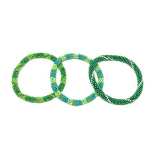 Load image into Gallery viewer, These &quot;Green Pear Roll Ons&quot; come as a set of three.  They are handmade with love by women artisans in Nepal, using high quality glass beads and hand-dyed cotton thread. These bracelets will expand over your hand to fit most wrist.   The purchase of these bracelets empowers female artisans through fair trade. Your purchase provides women with fair income + benefits in a safe and healthy work environment. Aid Through Trade empowers women by creating opportunity through beautifully designed jewelry.

