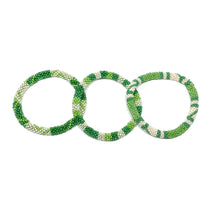 Load image into Gallery viewer, These &quot;Green Gecko Roll Ons&quot; come as a set of three.  They are handmade with love by women artisans in Nepal, using high quality glass beads and hand-dyed cotton thread. These bracelets will expand over your hand to fit most wrist.   The purchase of these bracelets empowers female artisans through fair trade. Your purchase provides women with fair income + benefits in a safe and healthy work environment. Aid Through Trade empowers women by creating opportunity through beautifully designed jewelry.
