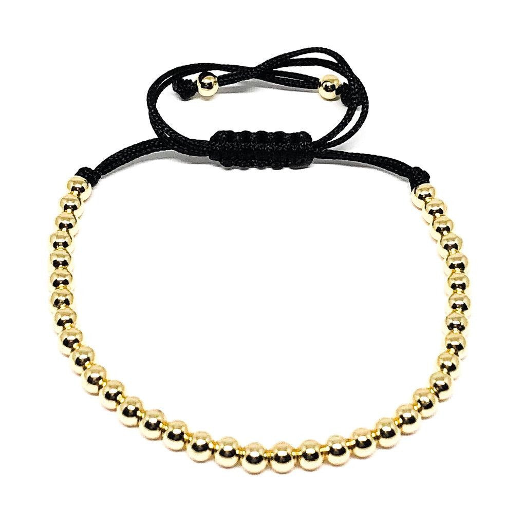 This 24k gold plated adjustable rope bracelet looks great on its own or stacked. An excellent addition to those who want to elevate their look. The adjustable bracelet ensures a perfect fit. Size fits S-L.  4mm 24k Gold Beads