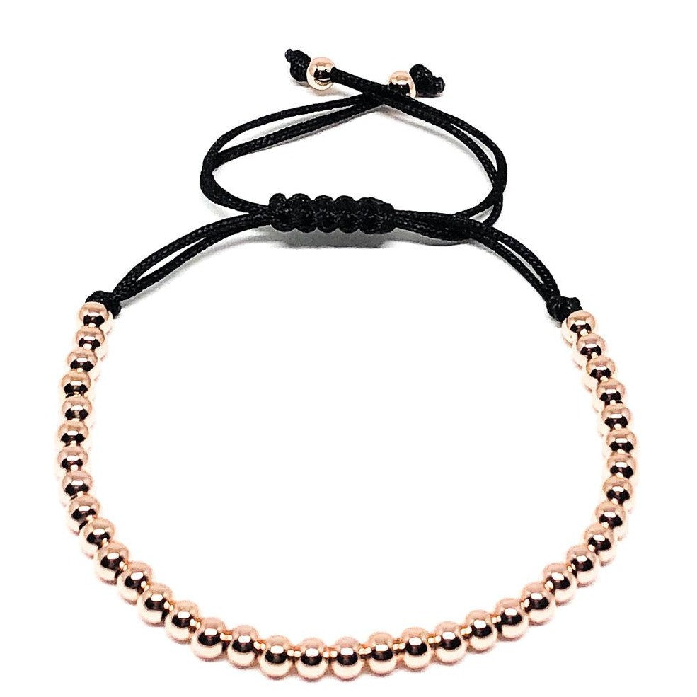This 24k rose gold plated adjustable rope bracelet looks great on its own or stacked. An excellent addition to those who want to elevate their look. The adjustable bracelet ensures a perfect fit. Size fits S-L.  4mm 24k Rose Gold Beads  Hypoallergenic