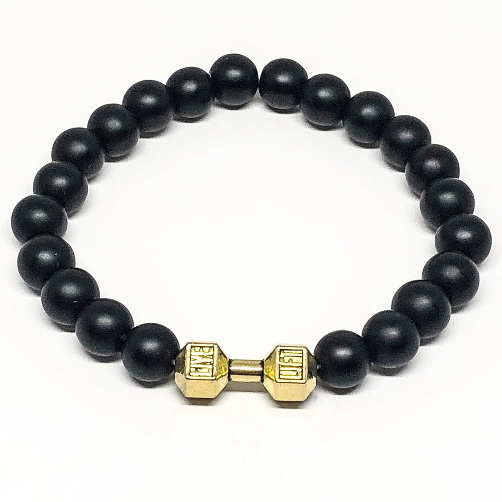 This black agate matte bracelet is perfect for the avid gym enthusiast.  Black agate is a grounding and protective stone. It gives a calming peace that helps those in periods of stress. The gold plated “live lift” dumbbell gives it a unique look.   8mm Black Agate Matte Beads   Gold Plated Brass 