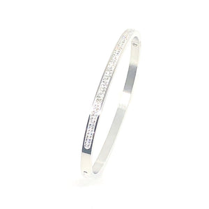 This stunning swarovski crystal bangle is made of surgical stainless steel. It can be worn with your evening outfit or dress up your jeans and shirt with this beautiful bangle.  The bangle is lead, nickel free and hypoallergenic  Has 2 rows of beautiful clear swarovski crystal  The circumference of this bangle is 2.5" and has an integrated snap closure