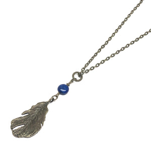 This Birds and Feather Gemstone Necklace features a stunning Lapis Lazuli gemstone and an antique bronze-colored feather for a trendy but timeless look.  This necklace is adjustable to approximately 32" in length  Pendant is 3.5" x 1"