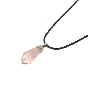 Rose quartz is a member of the largest family of stones, the silica group, and is composed of silicon dioxide with traces of titanium. It emits a calming, cooling energy which can work on all of the chakras to gently remove negativity and to reinstate the loving, gentle forces of self-love. Rose Quartz Pendant is approx 3cm x 1.5cm  The necklace is 18" in length on a black cord chain with a 1" extender.  Color, cut and shape of stone may vary