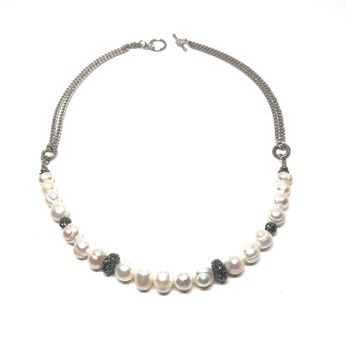 This stunning handcrafted genuine freshwater pearl necklace is designed to enhance your evening wear dress.  This necklace has czech crystals set between the freshwater pearls  This necklace is 20” in length and is rhodium plated  Designed and handcrafted by Canadian artisan