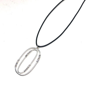 Discover eye-catching, straight-off-the-runway inspired pieces. One statement piece, infinite possibilities…  Merx Modern is exclusively designed and handmade in Canada.  This elegant long necklace is on a black cord and has a matte silver pendant with crystals   This necklace length is 30” + 3” extender  Pendant is 55mm x 30mm 