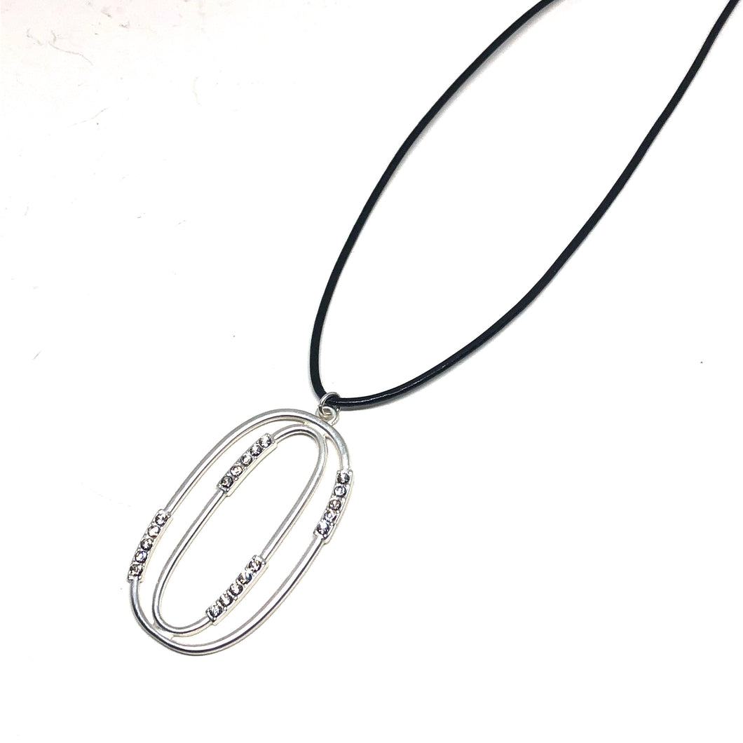 Discover eye-catching, straight-off-the-runway inspired pieces. One statement piece, infinite possibilities…  Merx Modern is exclusively designed and handmade in Canada.  This elegant long necklace is on a black cord and has a matte silver pendant with crystals   This necklace length is 30” + 3” extender  Pendant is 55mm x 30mm 