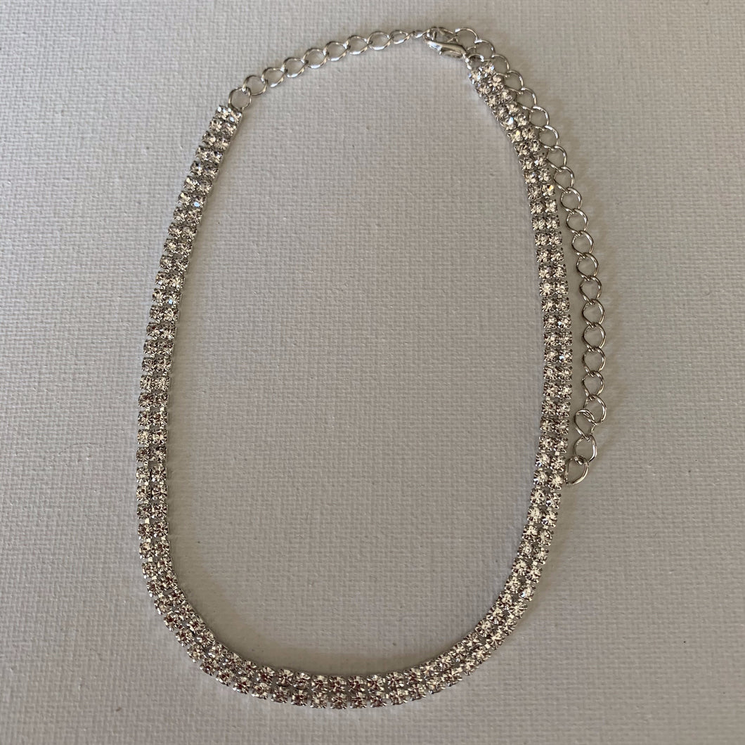 If you are going out to a party or a black tie event, this choker is the perfect accessory that will enhance your outfit. It features an amazing design and will suit any formal or casual ensemble.    It is hypoallergenic, lead and nickel free.    It has a double row of rhinestones.    The choker is 28 cm in length and has a 15 cm extender.  