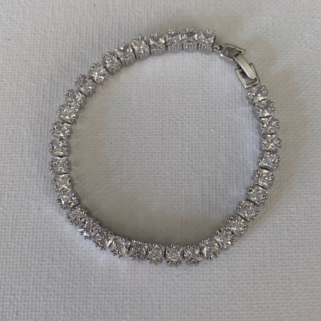 This stunning princess cut cubic zirconia bracelet is perfect to go with your bridal gown or for your bridesmaids or for the beautiful mother of the bride/groom.  It is also the perfect accessory to go with your evening dress.   This bracelet has high quality AAA+ cubic zirconia and is silver plated.   The bracelet is 18 cm in length and comes with a 2 cm extended clasp.    Lead, nickel and cadmium free 