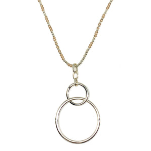 Discover eye-catching, straight-off-the-runway inspired pieces. One statement piece, infinite possibilities…  Merx Modern is exclusively designed and handmade in Canada.  This trendy and simple necklace has two light gold rings with a beige faceted bead chain.   This necklace length is 32+ 2” extender & clasp  Pendant is 2” x 2”