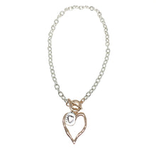 Load image into Gallery viewer, Discover eye-catching, straight-off-the-runway inspired pieces. One statement piece, infinite possibilities…  This short necklace has a rose gold heart with a silver love pendant.   Merx Modern is exclusively designed and handmade in Canada.  This necklace length is 20” + toggle closure
