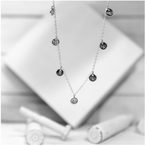 A classic multi-charm design that sits slightly looser than a choker, and is adjustable to fit various neck sizes. Each charm is stamped on both sides with B&U markings.  This necklace is silver plated stainless steel with a lobster clasp.   Length: 18” 