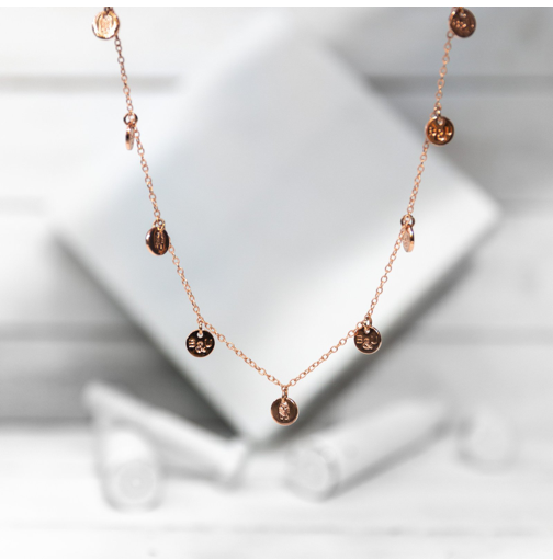 A classic multi-charm design that sits slightly looser than a choker, and is adjustable to fit various neck sizes. Each charm is stamped on both sides with B&U markings.  This necklace is rose gold plated stainless steel with a lobster clasp.   Length: 18” 