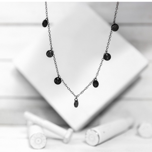 A classic multi-charm design that sits slightly looser than a choker, and is adjustable to fit various neck sizes. Each charm is stamped on both sides with B&U markings.  This necklace is titanium plated stainless steel with a lobster clasp.   Length: 18” 