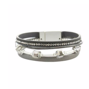 Leather bracelets are one of the hottest items of the season! Merx fashion bracelets are designed using high quality genuine leather, embellished with freshwater pearls, agate stones, and crystals. The metal used is pewter, zinc or brass. Nickel free & lead free.  This light grey leather bracelet is embellished with grey crystals and a row of clear rhinestones.   Magnetic clasp  Size: 8” in length  Width: 3/4" 