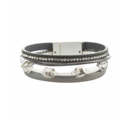 Leather bracelets are one of the hottest items of the season! Merx fashion bracelets are designed using high quality genuine leather, embellished with freshwater pearls, agate stones, and crystals. The metal used is pewter, zinc or brass. Nickel free & lead free.  This light grey leather bracelet is embellished with grey crystals and a row of clear rhinestones.   Magnetic clasp  Size: 8” in length  Width: 3/4