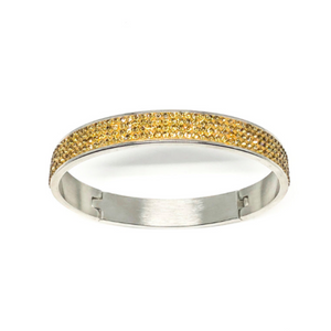 This swarovski bangle is made from surgical stainless steel and is 2.5" wide  This light topaz bangle has 4 rows of Swarovski Crystals set in a clay base  Hypoallergenic, lead and nickel free   This bangle is 2.75" in circumference and has a latching closure