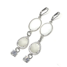 Load image into Gallery viewer, These beautiful earrings can we worn with your evening dress or dress them down and wear them with jeans.   Mother of Pearl crystal surrounded with Czech crystals   White gold plated frenchback closure   Both earrings have beautiful cubic zirconia 
