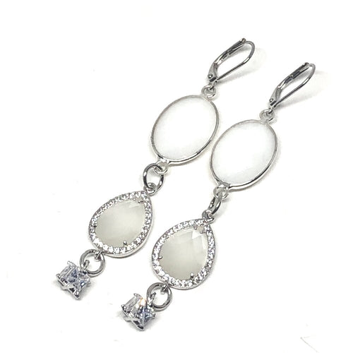 These beautiful earrings can we worn with your evening dress or dress them down and wear them with jeans.   Mother of Pearl crystal surrounded with Czech crystals   White gold plated frenchback closure   Both earrings have beautiful cubic zirconia 